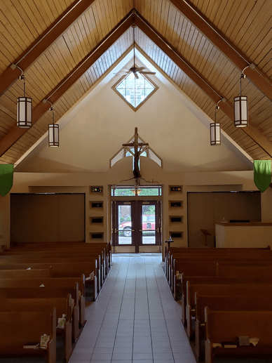 View of Sanctuary pews and front door, from chancel area